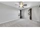 This is an empty carpeted bedroom with gray paint, two windows, and dark-colored curtains at 7511 S Sicily Way, Aurora, CO 80016