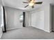 This carpeted bedroom features gray paint, a ceiling fan, and a closet at 7511 S Sicily Way, Aurora, CO 80016