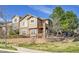 Inviting townhome exterior with stone accents, balcony and fenced front yard at 7511 S Sicily Way, Aurora, CO 80016