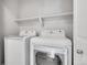 A laundry room with a white front-loading washing machine and dryer at 7511 S Sicily Way, Aurora, CO 80016