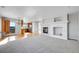 Spacious living room with fireplace, hardwood floors, and open floor plan to the kitchen at 7511 S Sicily Way, Aurora, CO 80016