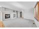 Open living room with fireplace, natural light and access to other living areas at 7511 S Sicily Way, Aurora, CO 80016
