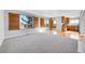 Spacious room with combined living space and kitchen and wooden shutters on the windows at 7511 S Sicily Way, Aurora, CO 80016