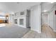 Open living room with fireplace, adjacent to kitchen and hallway at 7511 S Sicily Way, Aurora, CO 80016