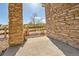 View of a patio with decorative brick pillars, gravel and a glimpse of the scenery beyond at 7511 S Sicily Way, Aurora, CO 80016