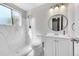 Bright bathroom featuring a walk-in shower with decorative tile and updated vanity at 807 Mobile St, Aurora, CO 80011