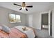 Comfortable bedroom with a ceiling fan, plush carpet and natural light at 807 Mobile St, Aurora, CO 80011