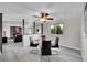 Bright dining room with a modern table and chairs, with an open layout and light from a large window at 807 Mobile St, Aurora, CO 80011