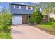 Charming two-story home featuring a brick facade, attached garage and well-maintained front yard at 807 Mobile St, Aurora, CO 80011