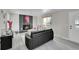 Bright living room with a fireplace and a black leather couch near a window, creating an inviting atmosphere at 807 Mobile St, Aurora, CO 80011