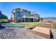 Beautiful backyard features a mini-golf area, sandbox, and lush grass for outdoor enjoyment at 4142 S Deframe Ct, Morrison, CO 80465