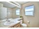 Functional bathroom with a single sink vanity, tiled shower, and a well-lit mirror at 4142 S Deframe Ct, Morrison, CO 80465