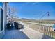 Outdoor deck featuring wicker patio furniture set with picturesque views and hummingbird feeder at 4142 S Deframe Ct, Morrison, CO 80465