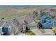 A cozy two-story home with a well-maintained lawn and landscaping, complemented by a scenic view of distant hills at 4142 S Deframe Ct, Morrison, CO 80465