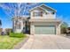 Charming two-story home featuring stone accents, a two-car garage, and a well-manicured lawn with beautiful landscaping at 4142 S Deframe Ct, Morrison, CO 80465