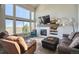 Spacious living room offering a fireplace, large windows with great natural light and comfortable seating at 4142 S Deframe Ct, Morrison, CO 80465