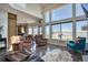Open concept living room showcasing a fireplace, hardwood floors and scenic views at 4142 S Deframe Ct, Morrison, CO 80465