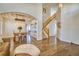 This living room is complemented by a beautiful wooden staircase and hardwood floors, creating an inviting atmosphere at 4142 S Deframe Ct, Morrison, CO 80465