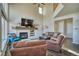 Cozy living room featuring a fireplace, tall ceilings, hardwood floors and comfortable seating at 4142 S Deframe Ct, Morrison, CO 80465
