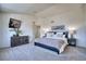 Comfortable main bedroom featuring soft carpet, ensuite access, and ample natural light at 4142 S Deframe Ct, Morrison, CO 80465