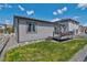 Well-maintained backyard is complete with a deck, green lawn and stone landscaping at 1868 Makley Loop, Castle Rock, CO 80104