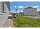 Landscaped backyard with a deck, lawn, and rock garden accents at 1868 Makley Loop, Castle Rock, CO 80104