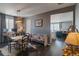 Stylish dining area with wood floors, unique lighting, and a cozy bench, adjacent to the living room at 1868 Makley Loop, Castle Rock, CO 80104