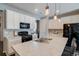 Bright kitchen with white cabinets, stainless steel appliances, and a large island with breakfast bar at 1868 Makley Loop, Castle Rock, CO 80104