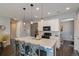 Modern kitchen with stainless steel appliances, white cabinets, and a large island with seating at 1868 Makley Loop, Castle Rock, CO 80104