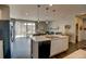 Spacious open-concept layout with living room and kitchen with pendant lighting and stainless appliances at 1868 Makley Loop, Castle Rock, CO 80104