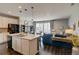 Open-concept floor plan featuring a kitchen with stainless appliances and living area with outdoor access at 1868 Makley Loop, Castle Rock, CO 80104