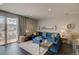 Inviting living room with a blue sectional, neutral decor, and sliding glass doors to the patio at 1868 Makley Loop, Castle Rock, CO 80104