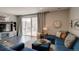 Cozy living room with a blue sectional, dark wood floors, and sliding glass doors at 1868 Makley Loop, Castle Rock, CO 80104