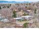 Aerial view of a neighborhood with trees and mountain views in the distance at 6445 Balsam St, Arvada, CO 80004