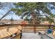 Spacious deck with outdoor seating, perfect for entertaining with mature trees and landscape at 6445 Balsam St, Arvada, CO 80004