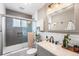 Modern bathroom featuring a glass-enclosed shower with gray tiling, white subway tile, and updated fixtures at 6445 Balsam St, Arvada, CO 80004