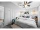 Charming bedroom features a ceiling fan, white walls, and cozy decor with floral pillows at 6445 Balsam St, Arvada, CO 80004