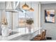 Bright, updated kitchen with a quartz island, barstool seating, modern fixtures, and a mountain view at 6445 Balsam St, Arvada, CO 80004