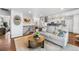 Bright living room with comfortable seating, open floorplan, and modern decor leading into the kitchen at 6445 Balsam St, Arvada, CO 80004