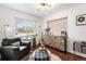 Stylish living room featuring hardwood floors, large window, and modern furnishings at 6445 Balsam St, Arvada, CO 80004