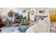 Cozy living room with comfortable seating, hardwood floors, and a decorative rug near the yellow front door at 6445 Balsam St, Arvada, CO 80004