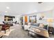 Spacious living room with large sectional sofa, coffee table, and dining area, great for entertaining or relaxation at 6445 Balsam St, Arvada, CO 80004