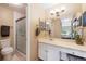 Comfortable bathroom features a glass-enclosed shower, a large vanity, and neutral decor with easy access to the bedroom at 8433 S Painted Sky St, Highlands Ranch, CO 80126