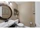 Stylish powder room with a round mirror, sleek faucet, and modern finishes at 8433 S Painted Sky St, Highlands Ranch, CO 80126