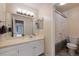 Clean bathroom design showcasing neutral countertops, an oversized mirror, tile floors, and easy access to other rooms at 8433 S Painted Sky St, Highlands Ranch, CO 80126