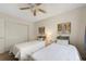 Cozy bedroom featuring twin beds, ceiling fan, neutral paint, and closet with sliding doors at 8433 S Painted Sky St, Highlands Ranch, CO 80126