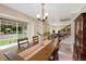 Bright dining room featuring a stylish light fixture, large window, and hardwood table at 8433 S Painted Sky St, Highlands Ranch, CO 80126