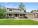 Inviting two-story home featuring a well-manicured lawn and a charming brick facade at 8433 S Painted Sky St, Highlands Ranch, CO 80126