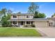 Charming two-story home with a well-manicured front yard, beautiful landscaping, and a two-car garage at 8433 S Painted Sky St, Highlands Ranch, CO 80126