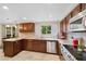 Well-lit kitchen boasts granite countertops, stainless steel appliances, tile backsplash, and abundant cabinet space at 8433 S Painted Sky St, Highlands Ranch, CO 80126
